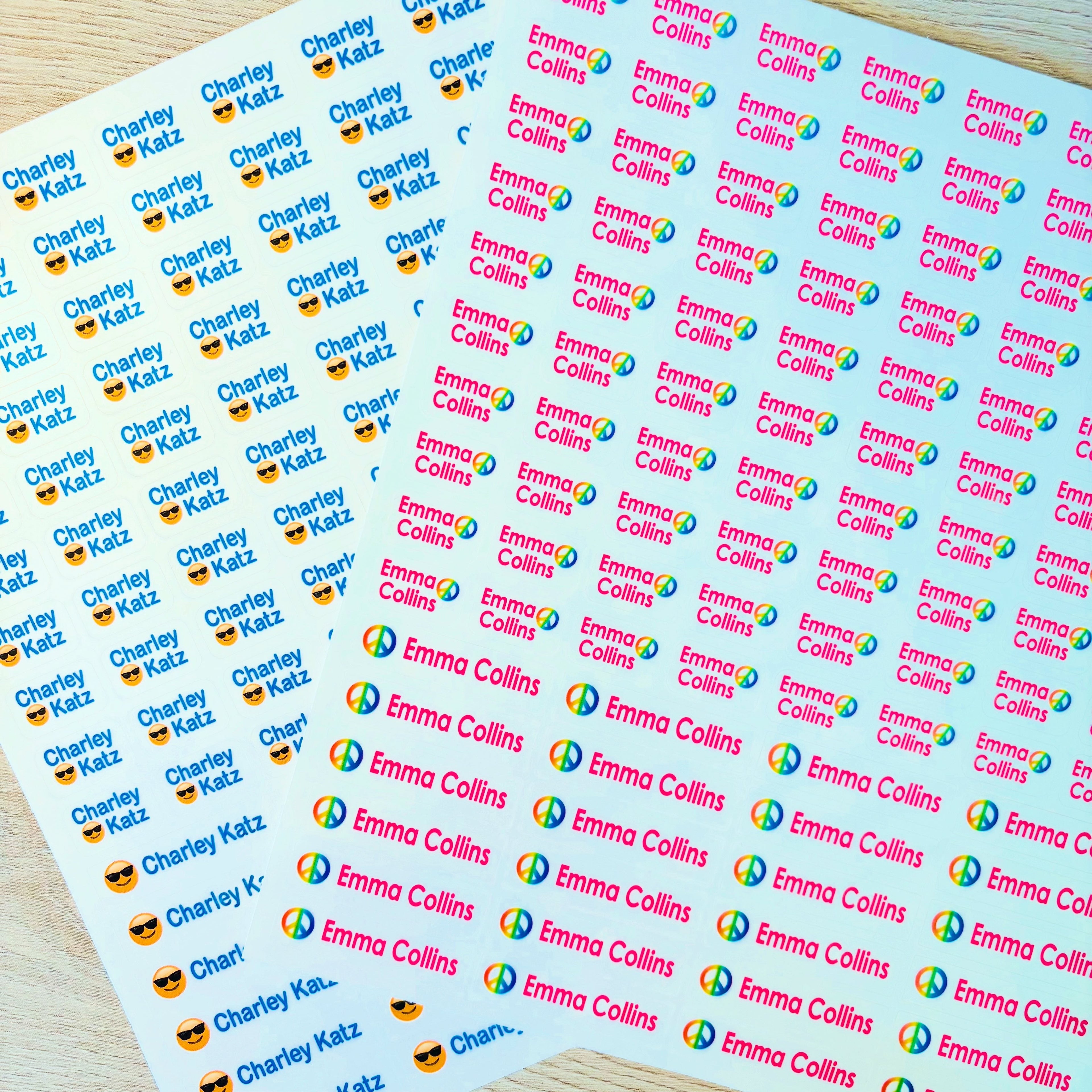 Sheets of personalized stickers with names and logos on a wooden surface