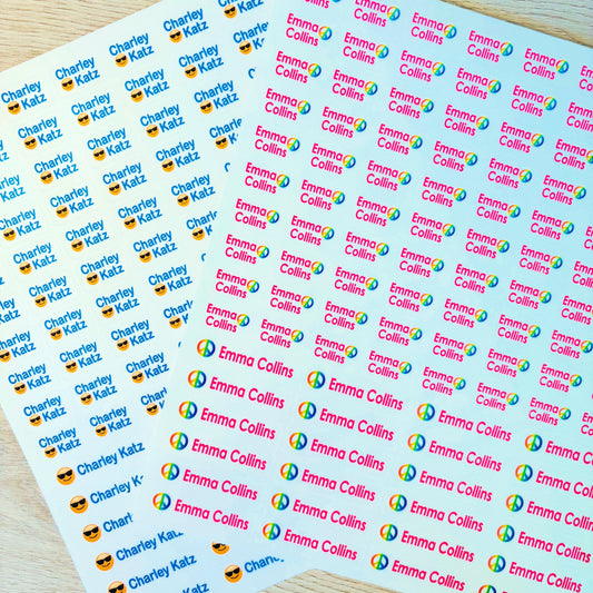 Sheets of personalized stickers with names and logos on a wooden surface